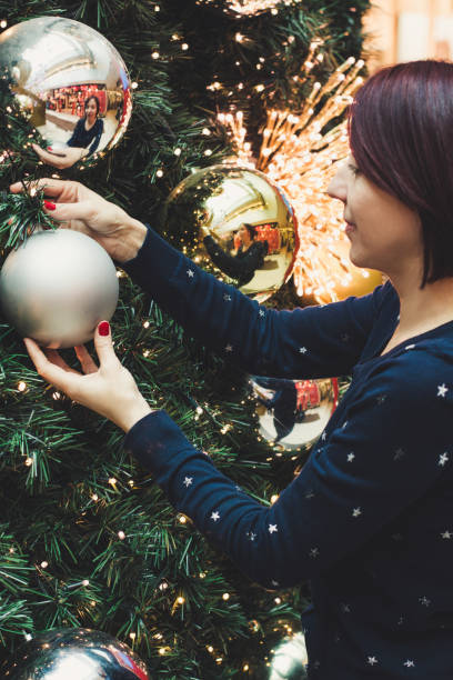 istock Women decorating a Christmas tree 1068510526