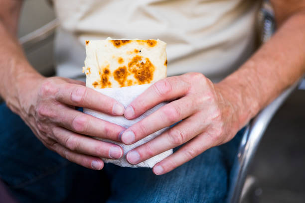 hands holding fast food in bar