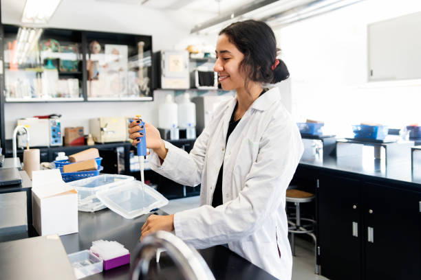 istock Asian young woman student in college science laboratory. 1068513198