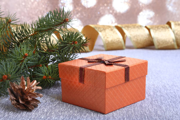 istock Christmas decoration with gift boxes, christmas tree and cones on a blurry, sparkling and fabulous background. 1068515880