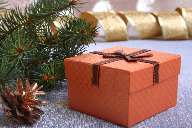 istock Christmas decoration with gift boxes, christmas tree and cones on a blurry, sparkling and fabulous background. 1068515976