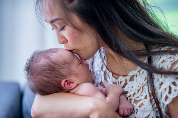 istock Mother embracing her newborn baby 1068517788