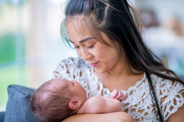 istock Mother embracing her newborn baby 1068517796