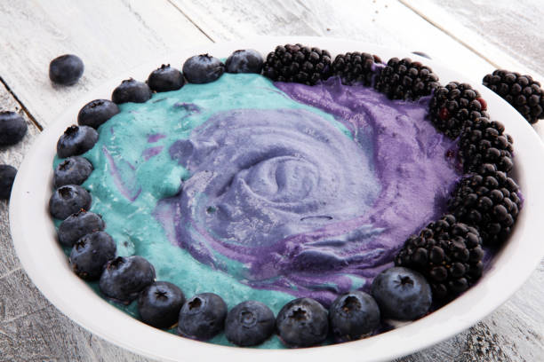 Healthy breakfast. smoothie bowl with blackberries and granola on rustic background
