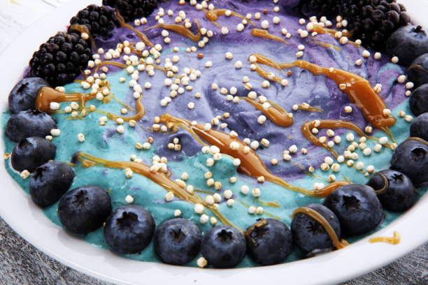 Healthy breakfast. smoothie bowl with blackberries and granola on rustic background