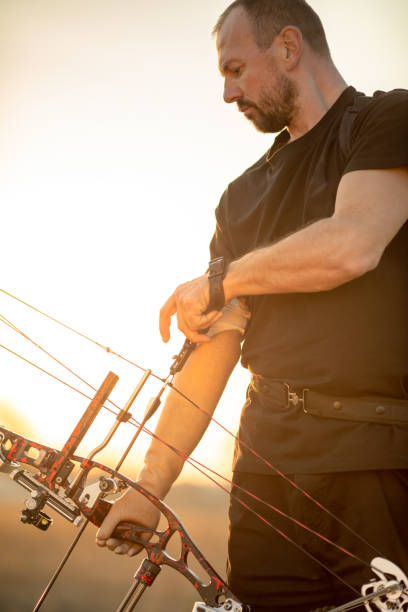 istock Man with prosthetic arm doing archery outdoors 1068537348