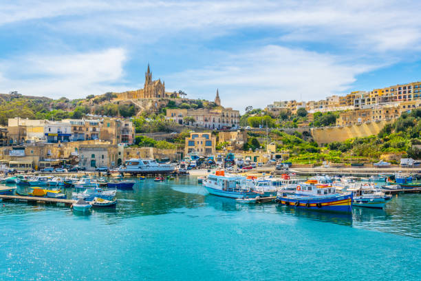 Fishing boats moor in Mgarr, Gozo, Malta Fishing boats moor in Mgarr, Gozo, Malta mgarr malta island gozo cityscape with harbor stock pictures, royalty-free photos & images
