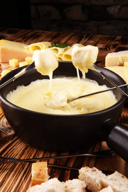 istock Gourmet Swiss fondue dinner on a winter evening with assorted cheese 1068538290