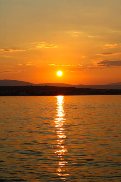 istock Sunset and clouds near Malinska, Croatia 1068540632