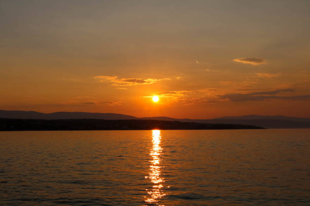 istock Sunset and clouds near Malinska, Croatia 1068540638