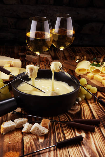 istock Gourmet Swiss fondue dinner on a winter evening with assorted cheese 1068541086