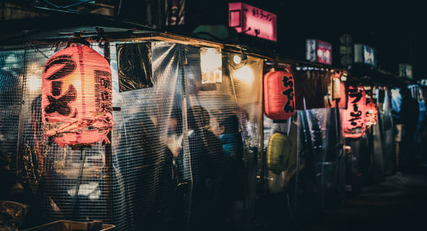 "Yatai" Japanese food stalls late at night in Fukuoka, Japan Japanese street food sold out of "yatai" food stalls in Fukuoka (Hakata), Japan. Signs say "ramen," "oden," "Hakata ramen" with no business names visible. fukuoka city stock pictures, royalty-free photos & images