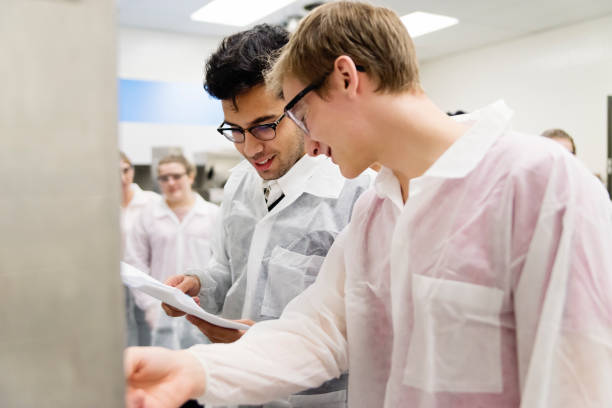 istock Multi-ethnic group of students in College pharmaceutical laboratory. 1068544762