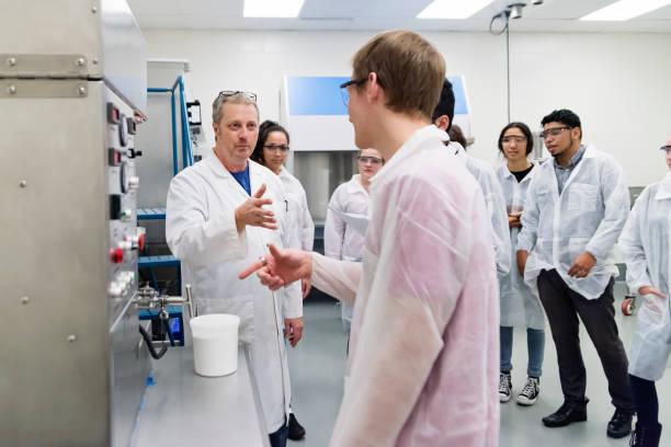 istock Multi-ethnic group of students in College pharmaceutical laboratory. 1068544954