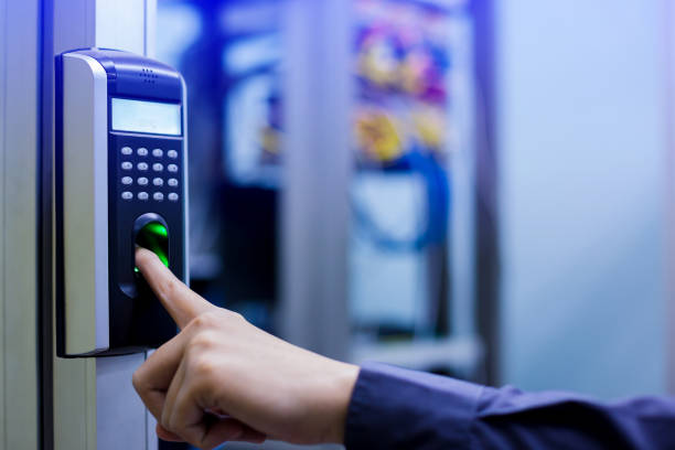 istock Staff push down electronic control machine with finger scan to access the door of control room or data center. 1068548076