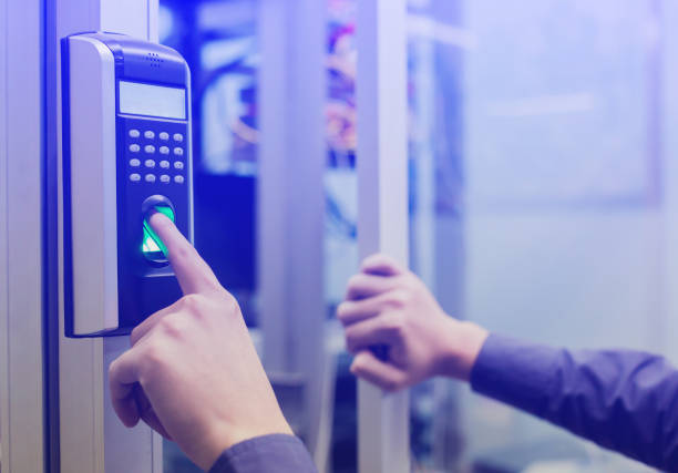 istock Staff push down electronic control machine with finger scan to access the door of control room or data center. 1068548506