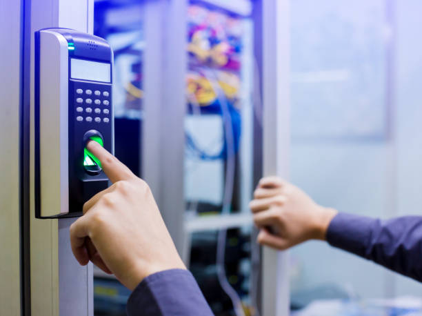 istock Staff push down electronic control machine with finger scan to access the door of control room or data center. 1068548530