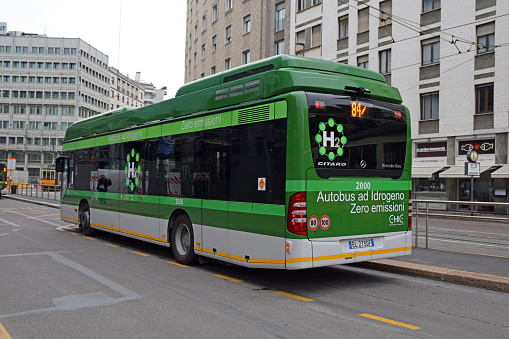 Milan, Italy - May 28th, 2018: Mercedes-Benz Citaro FuelCell Hybrid stopped on the bus stop. This vehicle is one of the first fuel cell, hydrogen buses in the world. This model is equipped in a fuel cell who generates electricity through the chemical reaction between hydrogen and oxygen to power the motor driving the vehicle. The hydrogen replaces gasoline as fuel in future.