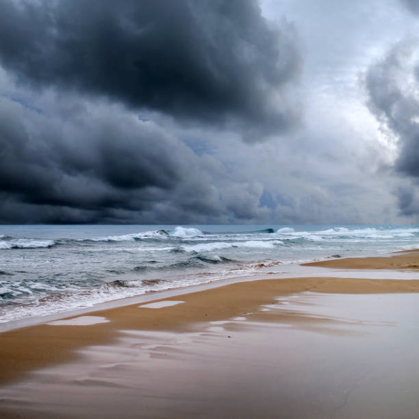 istock Windy seascape with waves over storm sky 1068549592