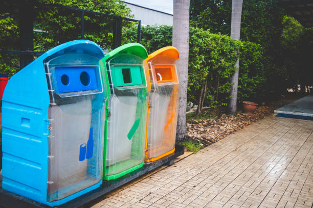 istock Colorful Garbage Cans On Footpath In City 1068551356