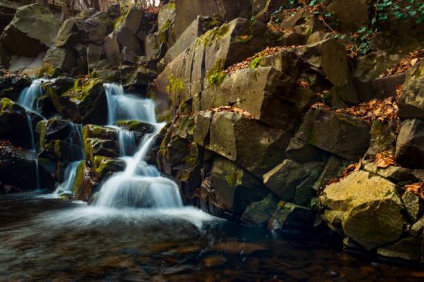 istock Flowing stream and waterfall in autumn forest 1068553308