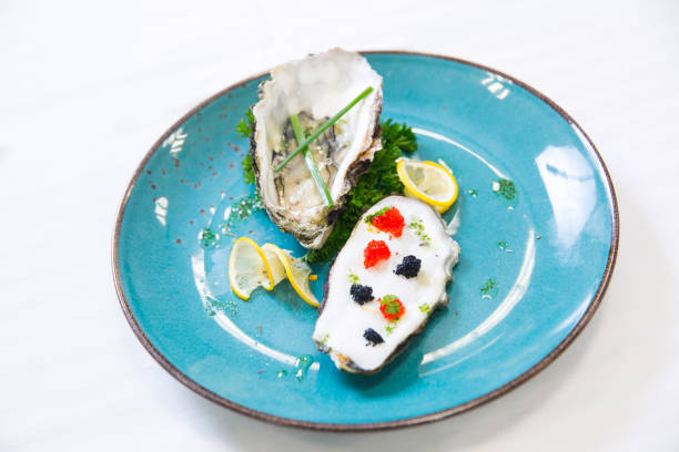 istock Fresh oysters with red and black caviar 1068554900