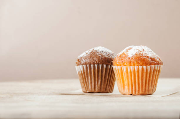 istock Lemon and chocolate muffins on a wooden table. Space for text. 1068555784