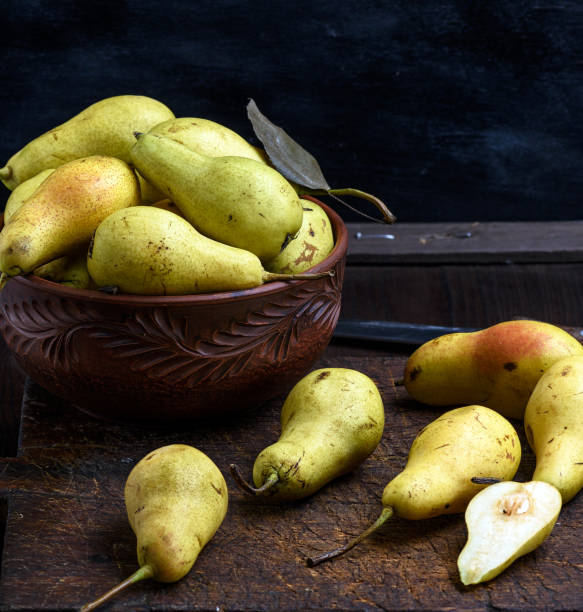 istock ripe green pears in a brown clay bowl 1068558400
