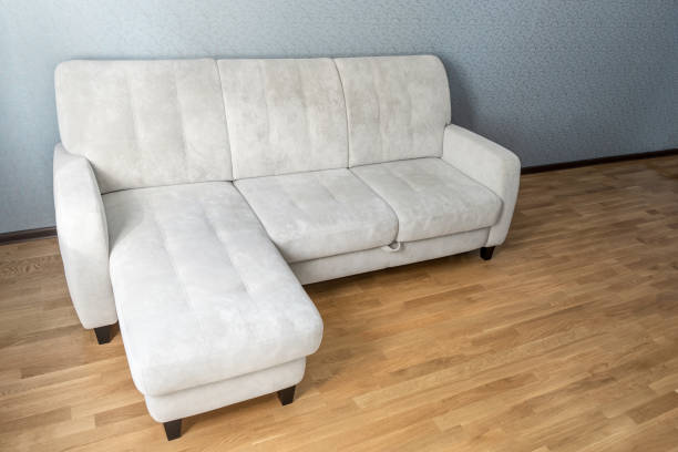 istock beige Sofa on laminate floor in empty living room 1068560484