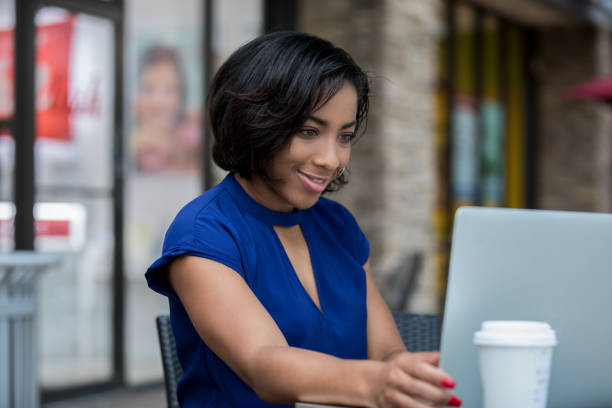 istock Young adult African American creative professional using laptop while working remotely 1068563348