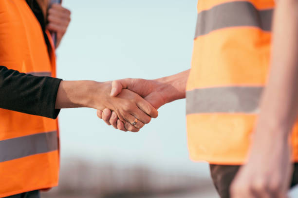 istock Close-Up Of Engineers Shaking Hands 1068572180