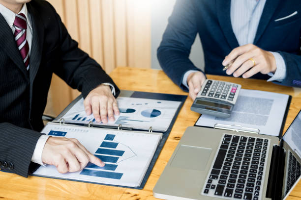 istock Midsection Of Businessmen Doing Paperwork At Desk In Office 1068572434