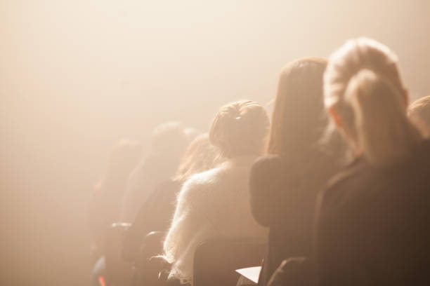 istock People Sitting On Chairs In Darkroom 1068572442