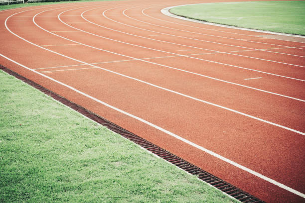 istock Running track for athletic competition texture. Race for training sport with lane background copy space, nobody runner tracks athietic competition in sunny day. 1068584624