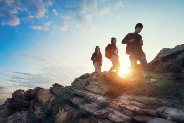 istock Young asian couple climbing up on the mountain 1068594100