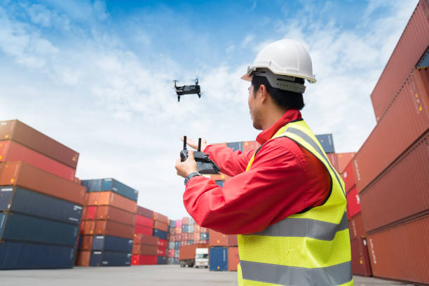 istock Foreman control drone to fly to survey the area worth in container yard 1068594252