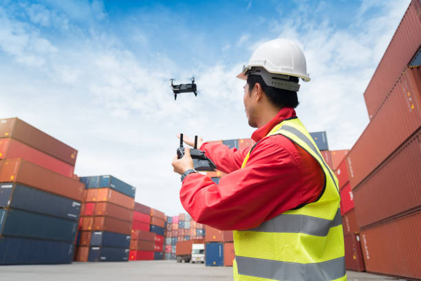 Foreman control drone to fly to survey the area worth in container yard Foreman control drone to fly to survey the area worth in container yard af_istocker stock pictures, royalty-free photos & images