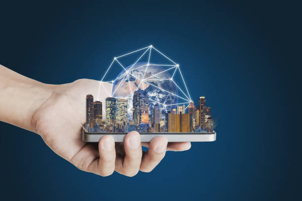 istock Hand holding mobile smart phone with modern buildings global network connection technology hologram. Element of this image are furnished by NASA 1068595306