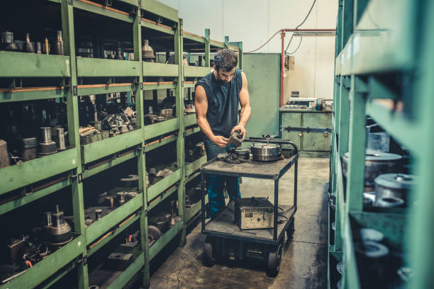 Worker Searching for the Right Tool in Workshop stock photo
