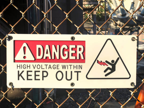 High Voltage sign on a fence stock photo