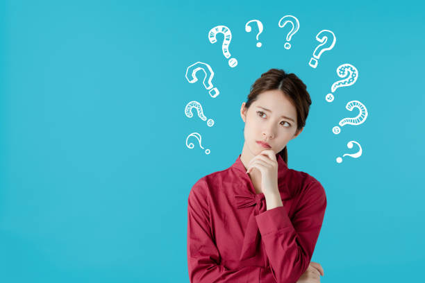istock Thinking asian woman. 1068618334
