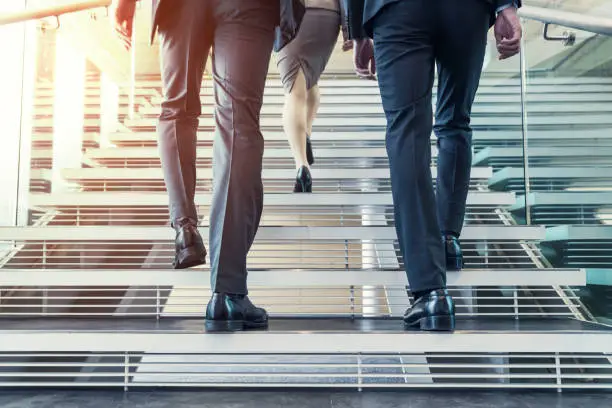 Photo of Business persons going up the stairs.