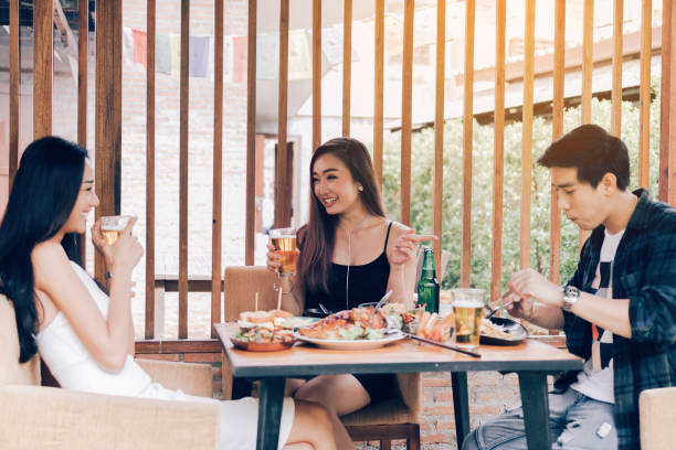 istock Asian people cheering beer at restaurant happy hour and laughing. 1068620976