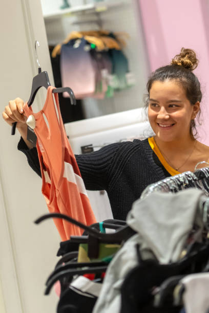istock young woman shopping for clothes 1068622810