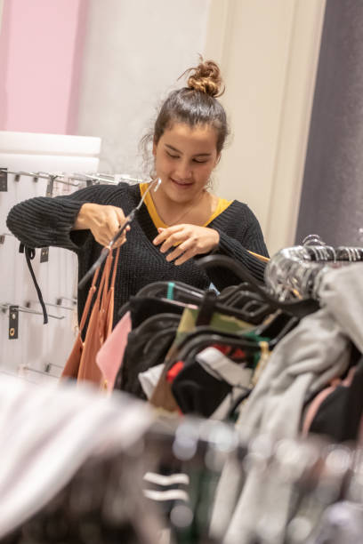 istock young woman shopping for clothes 1068622812