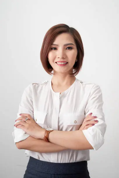 Photo of Entrepreneur young asian woman, business woman arms crossed on white background.
