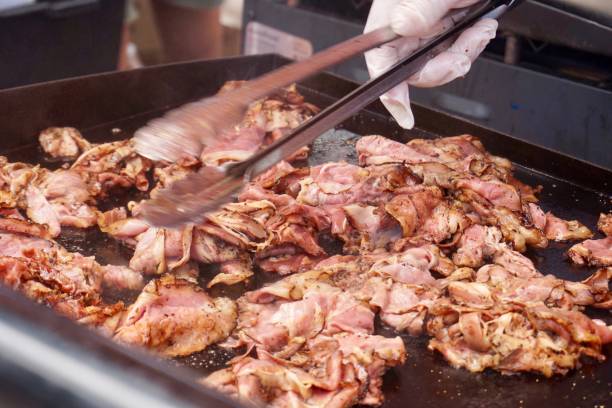 istock Tossing meat on a flat top grill 1068629534