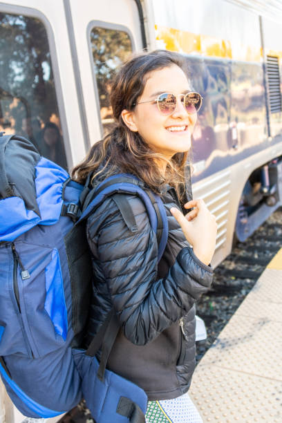 istock Smiling young woman posing smiling carrying her backpack 1068633136