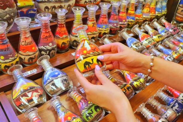 istock Arabian style Sand in Bottles with hands 1068633718