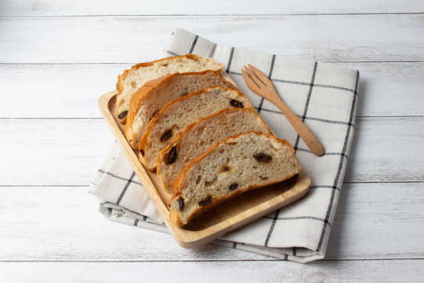 istock slices raisin bread on wooden board 1068635242